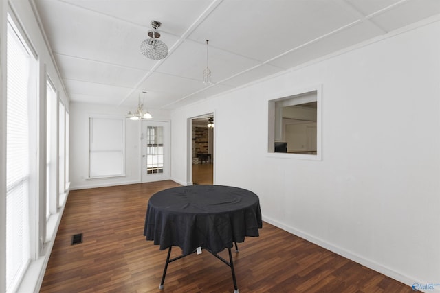 dining area with a chandelier and dark hardwood / wood-style flooring