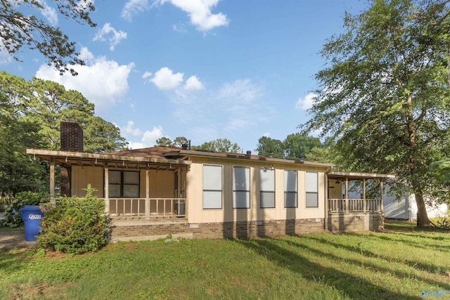 back of house with a porch and a lawn