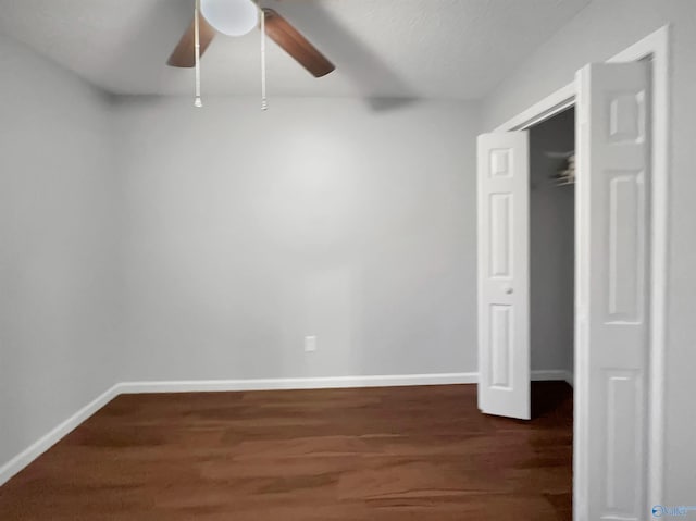 107 Patra Dr, Madison, AL 35758 - unfurnished bedroom with dark wood-type flooring, a ceiling fan, and a closet