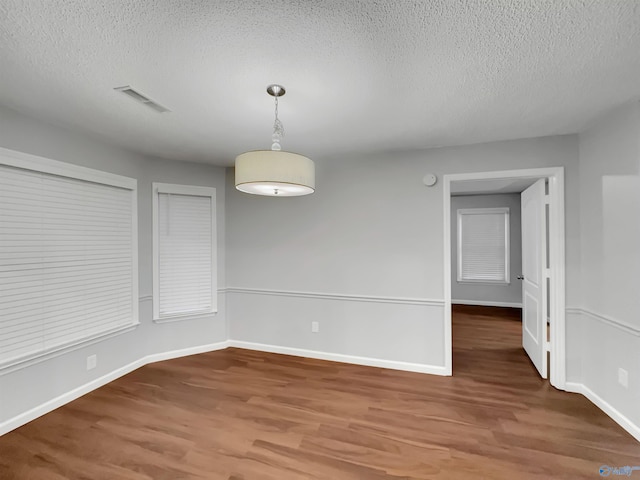 107 Patra Dr, Madison, AL 35758 - empty room with wood finished floors and a textured ceiling