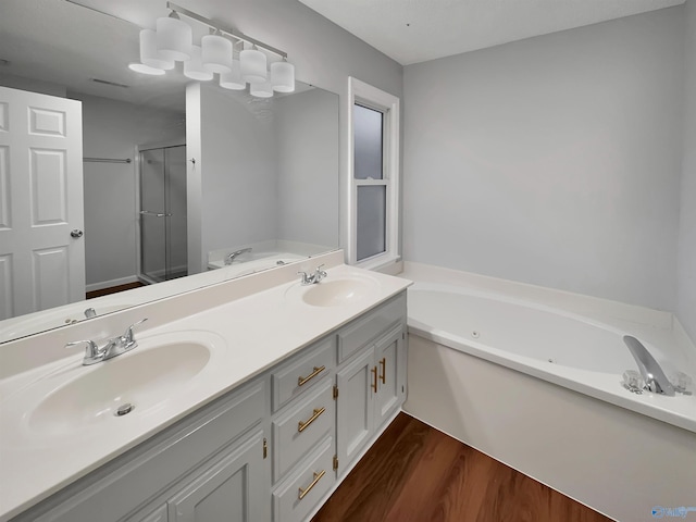 107 Patra Dr, Madison, AL 35758 - full bathroom featuring a whirlpool tub, a stall shower, wood finished floors, and double vanity