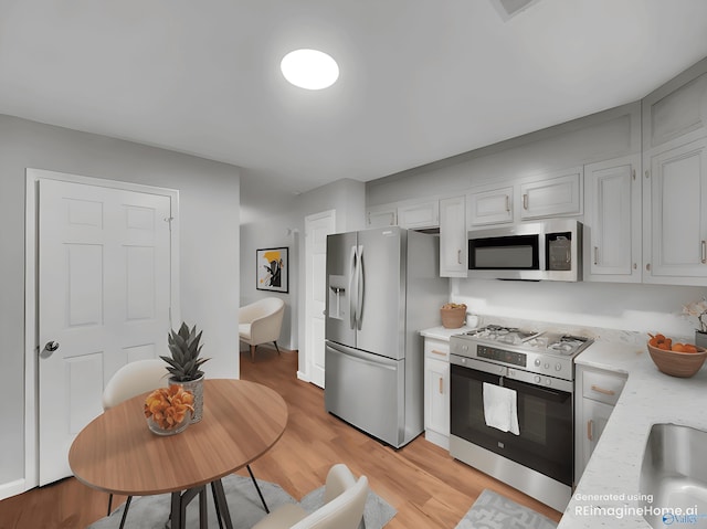 107 Patra Dr, Madison, AL 35758 - kitchen featuring appliances with stainless steel finishes, light wood finished floors, and light stone countertops