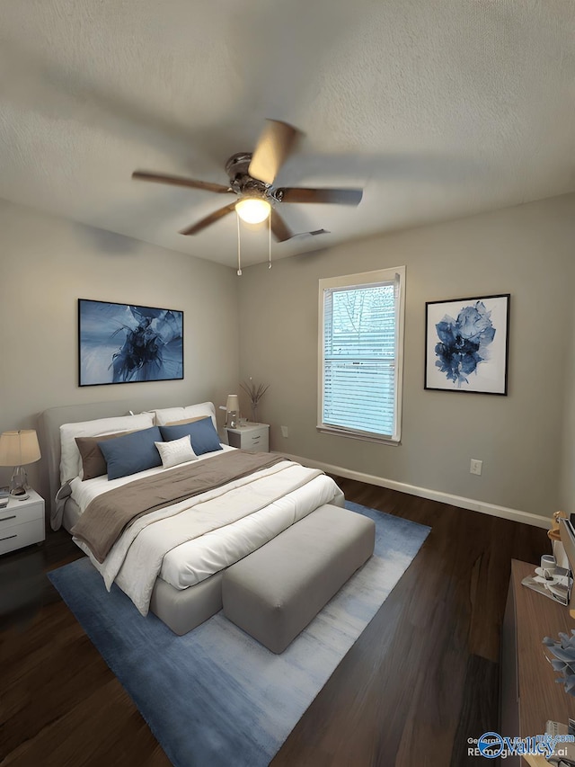 107 Patra Dr, Madison, AL 35758 - bedroom with dark wood-style flooring, a textured ceiling, and a ceiling fan