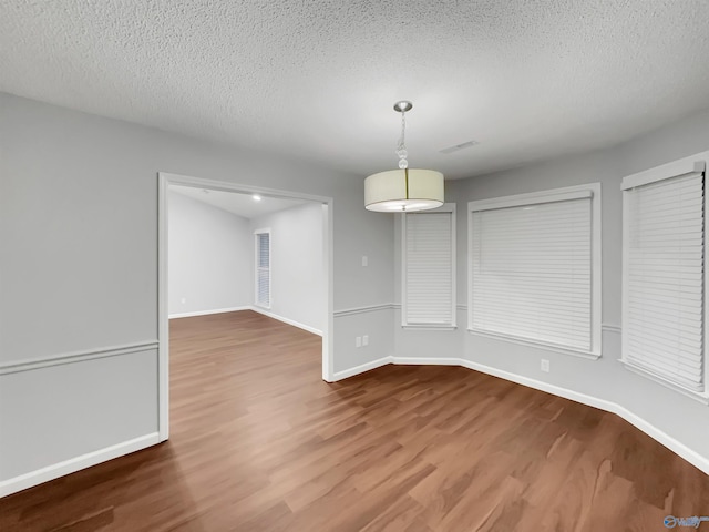 107 Patra Dr, Madison, AL 35758 - unfurnished dining area featuring wood finished floors and a textured ceiling