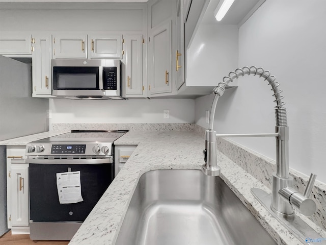 107 Patra Dr, Madison, AL 35758 - kitchen featuring stainless steel appliances and light stone counters