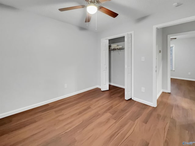 107 Patra Dr, Madison, AL 35758 - unfurnished bedroom featuring wood finished floors, a closet, and a ceiling fan