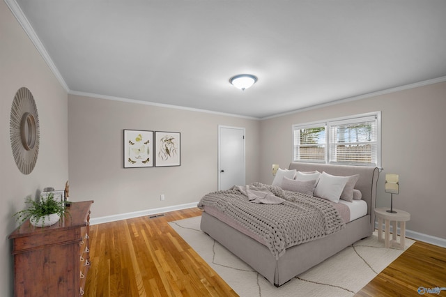 bedroom featuring hardwood / wood-style floors and crown molding