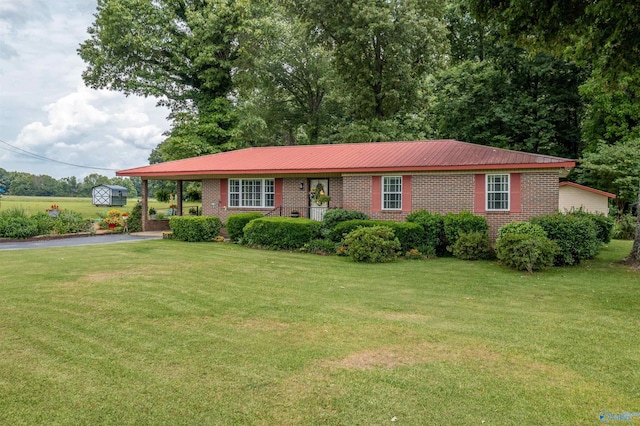 7250 County Road 113, Centre, AL 35960 - single story home featuring brick siding, a front yard, metal roof, and driveway