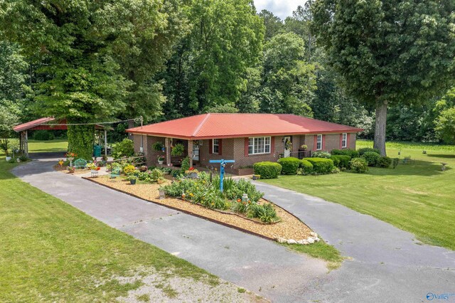 7250 County Road 113, Centre, AL 35960 - ranch-style home featuring a front yard, brick siding, a carport, and aphalt driveway