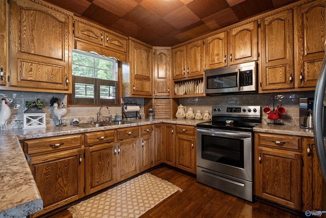 7250 County Road 113, Centre, AL 35960 - kitchen with tasteful backsplash, brown cabinetry, a sink, and stainless steel appliances