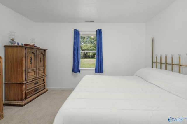 bedroom featuring light carpet