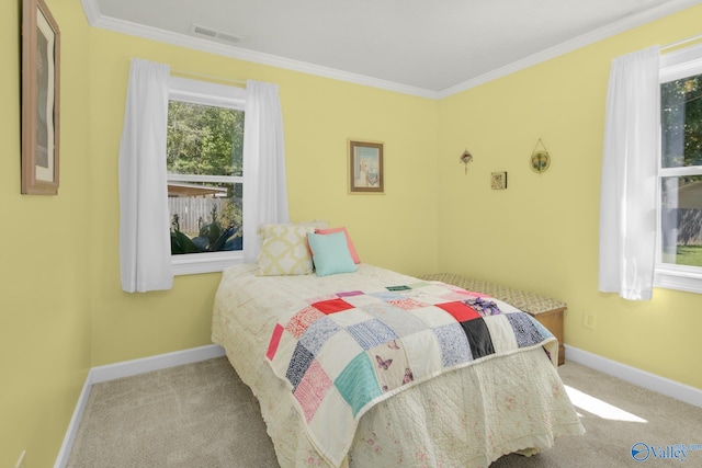 bedroom with ornamental molding and light carpet