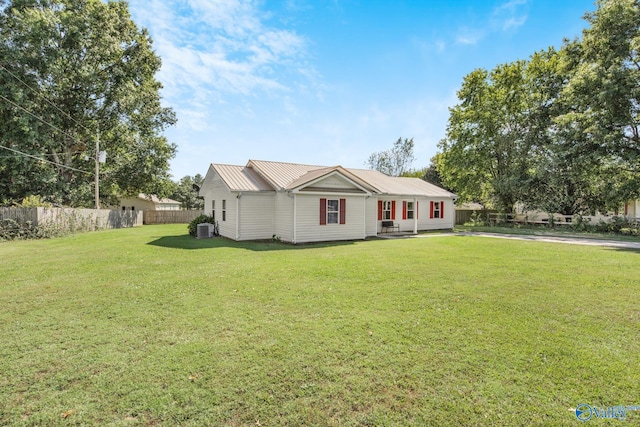 ranch-style house with central AC and a front lawn