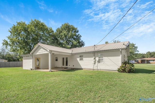 back of property featuring a lawn and a patio area