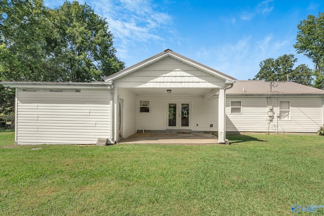 rear view of house featuring a patio, french doors, and a yard