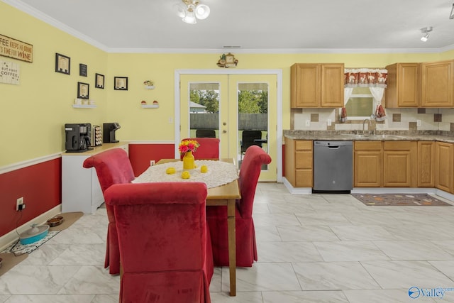 dining area with ornamental molding, sink, and french doors