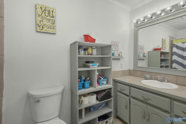 bathroom featuring ornamental molding, vanity, and toilet