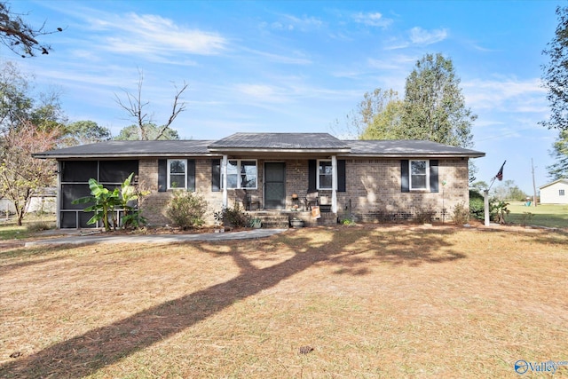 ranch-style house with a sunroom and a front yard