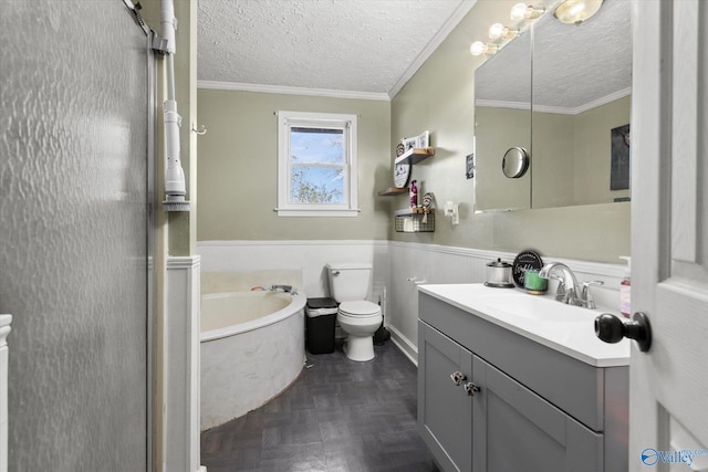 bathroom with a textured ceiling, vanity, ornamental molding, and a tub