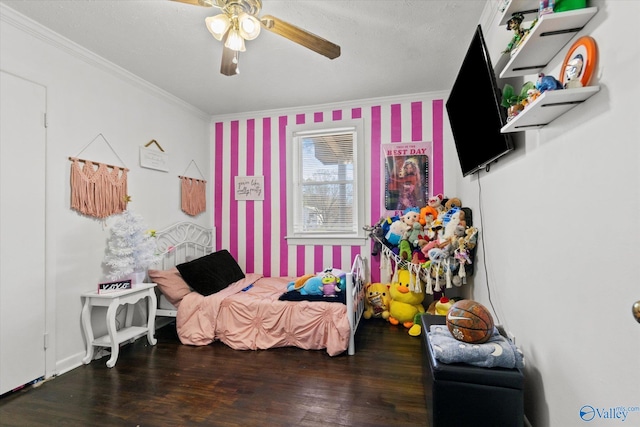 bedroom with ceiling fan, dark hardwood / wood-style flooring, ornamental molding, and a textured ceiling