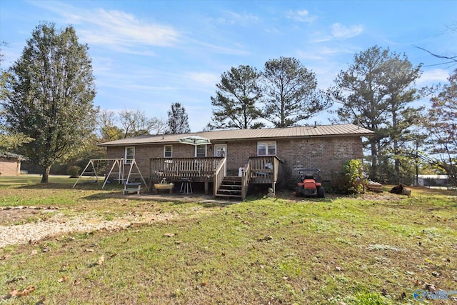 rear view of house with a lawn and a deck