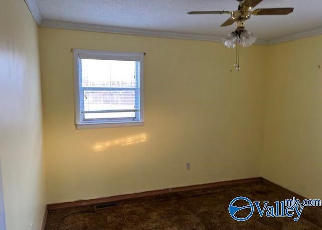 carpeted spare room with crown molding and ceiling fan