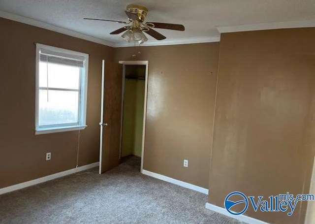 unfurnished bedroom featuring crown molding, light colored carpet, a closet, and ceiling fan