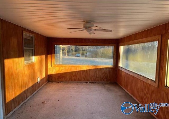 unfurnished sunroom with ceiling fan