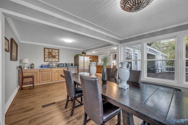 dining space with wooden ceiling, hardwood / wood-style flooring, and crown molding