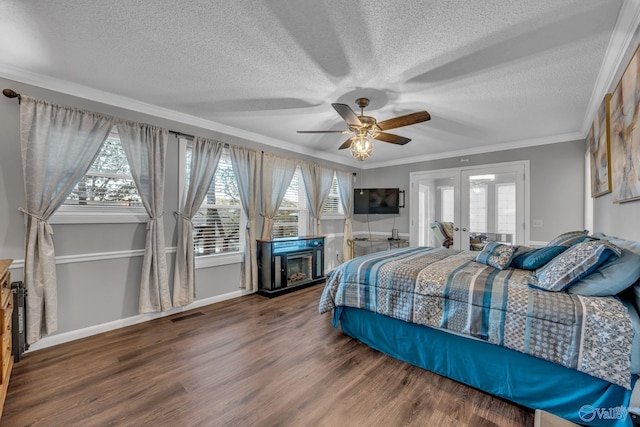 bedroom featuring french doors, hardwood / wood-style floors, a textured ceiling, ornamental molding, and ceiling fan