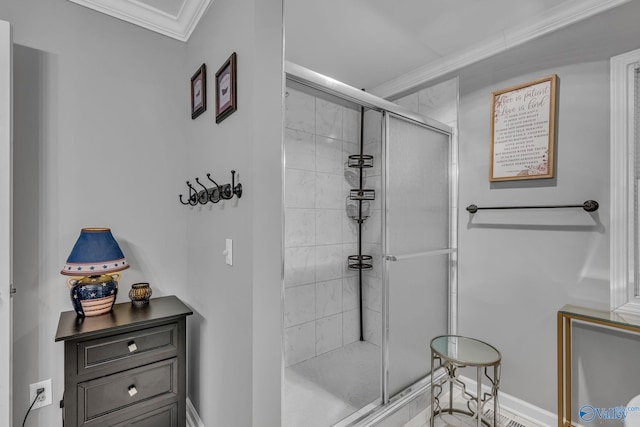 bathroom featuring a shower with shower door and crown molding