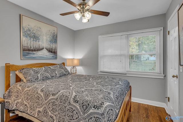 bedroom with dark wood-type flooring and ceiling fan