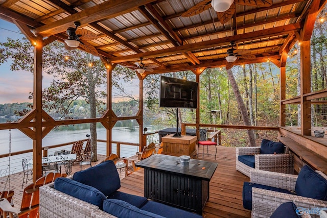 deck at dusk featuring an outdoor hangout area and ceiling fan