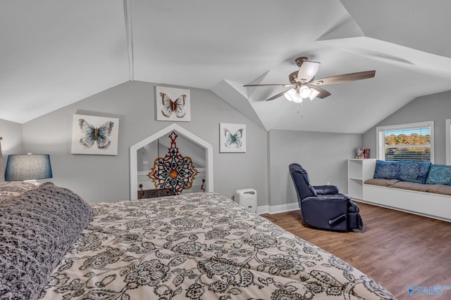 bedroom featuring hardwood / wood-style floors, vaulted ceiling, and ceiling fan