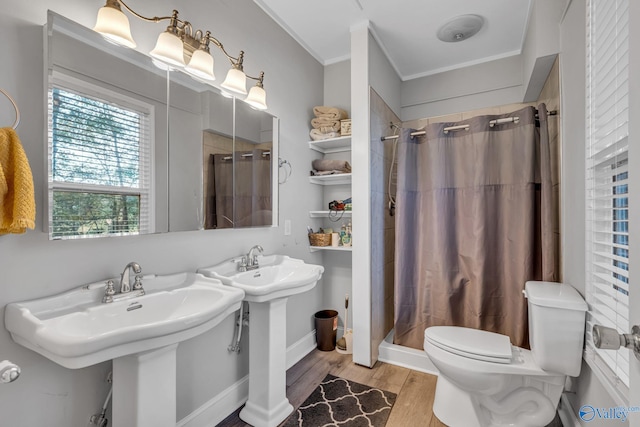 bathroom featuring toilet, curtained shower, wood-type flooring, and crown molding