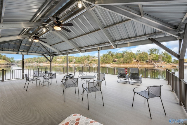 view of patio featuring a water view, ceiling fan, and a gazebo