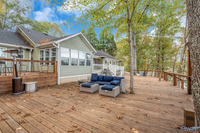 wooden deck with an outdoor living space