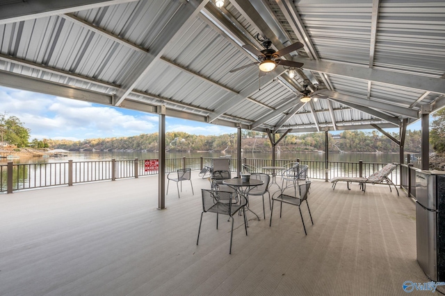 view of patio / terrace with ceiling fan, a gazebo, and a water view