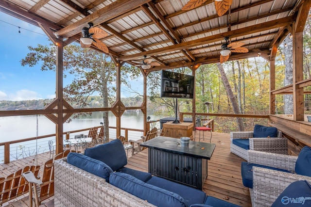 wooden terrace with an outdoor hangout area and ceiling fan