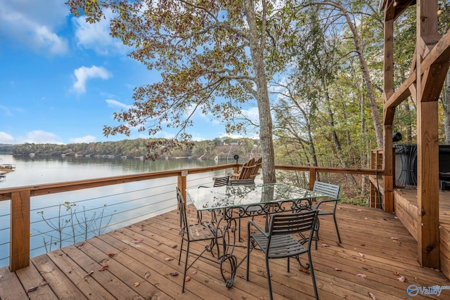 wooden terrace featuring a water view