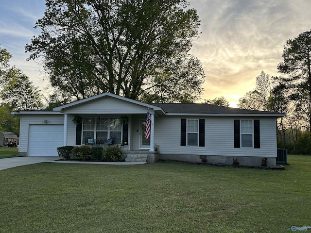 single story home featuring central AC unit, a yard, covered porch, a garage, and concrete driveway