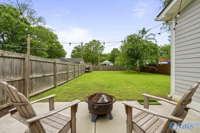 view of yard featuring a fire pit and a patio area