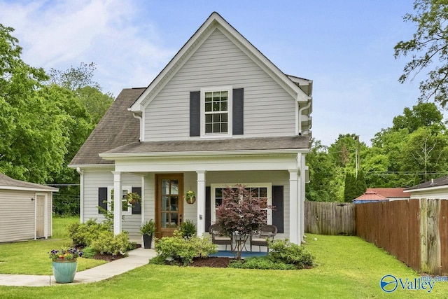 back of house with a porch and a shingled roof