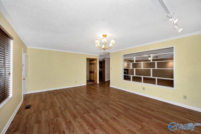 unfurnished living room with a chandelier, a textured ceiling, wood finished floors, and visible vents