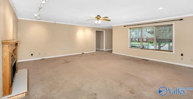 unfurnished living room with baseboards, crown molding, and a ceiling fan