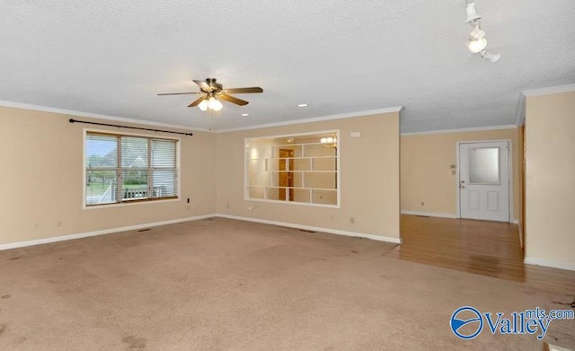 unfurnished room featuring crown molding, baseboards, and a ceiling fan