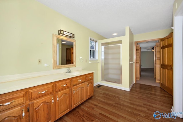 full bath with visible vents, a stall shower, wood finished floors, and vanity