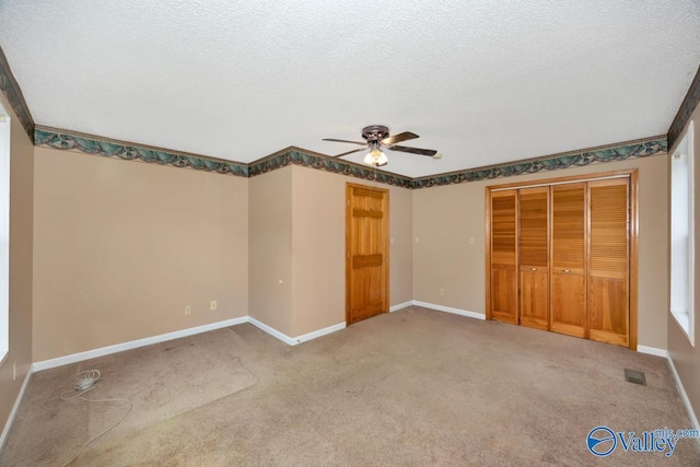 unfurnished bedroom with carpet floors, baseboards, and visible vents