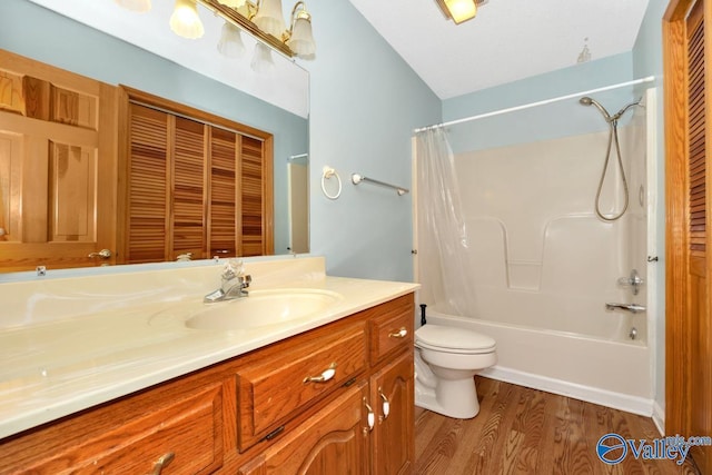 bathroom with toilet, shower / bath combo, wood finished floors, and vanity