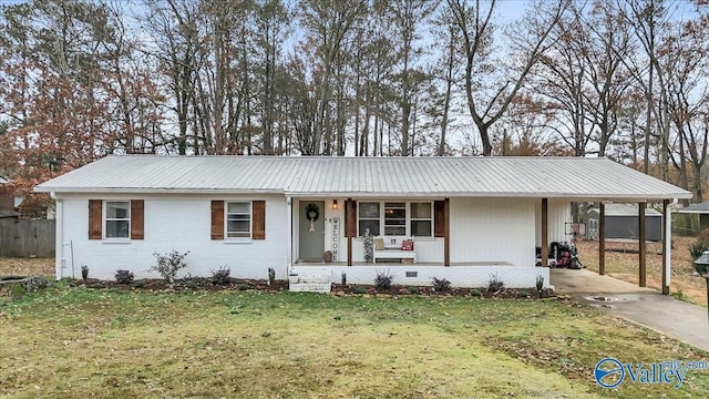 ranch-style home with covered porch, a front lawn, and a carport